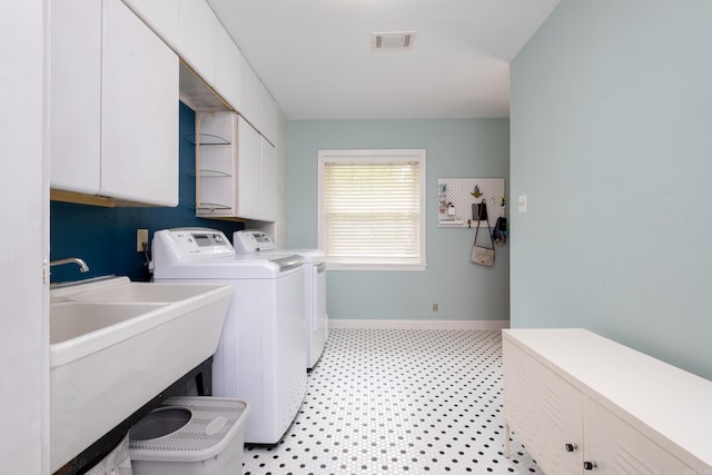 375 Goshen Ave, North Little Rock, AR 72116 - clothes washing area featuring cabinet space, washing machine and clothes dryer, baseboards, and light flooring