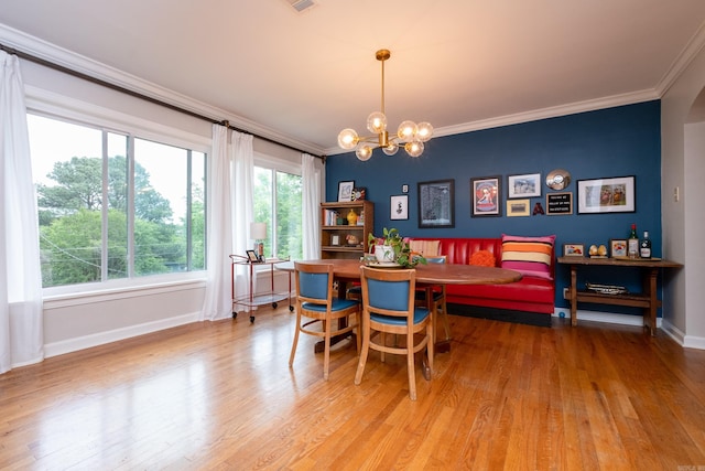 375 Goshen Ave, North Little Rock, AR 72116 - dining space with ornamental molding, light wood finished floors, baseboards, and a chandelier
