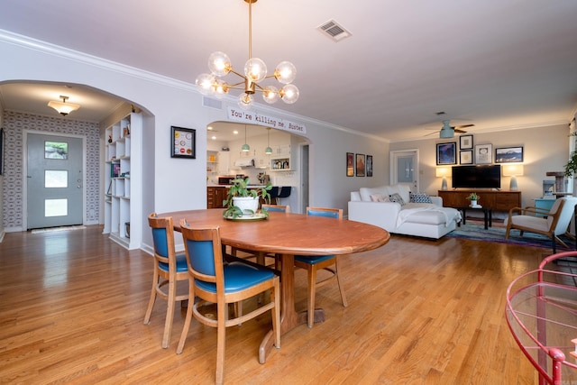 375 Goshen Ave, North Little Rock, AR 72116 - dining space with arched walkways, ceiling fan, ornamental molding, a chandelier, and light wood-style floors