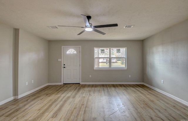 foyer entrance with wood finished floors, a ceiling fan, and baseboards