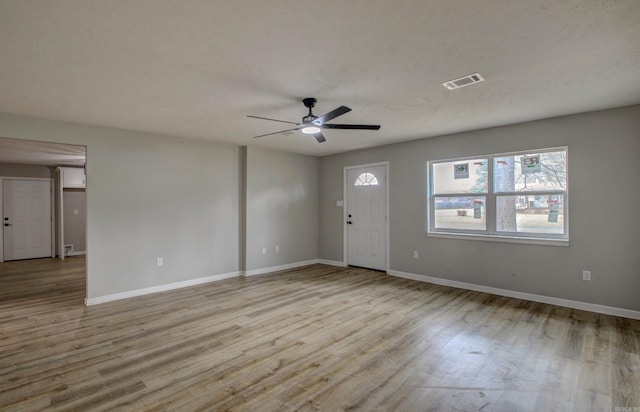 entrance foyer with ceiling fan, wood finished floors, and baseboards