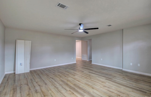 empty room featuring wood finished floors, ceiling fan, and baseboards