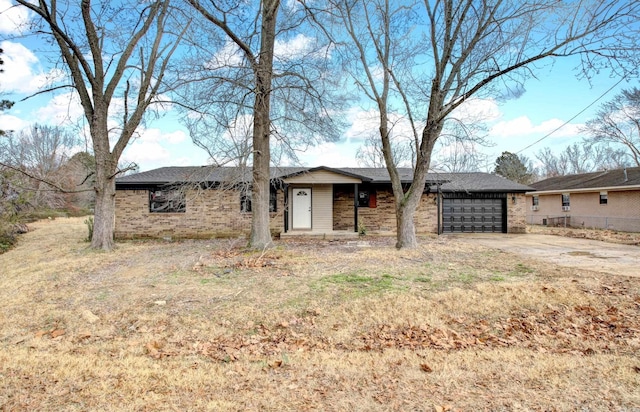 view of front of home featuring brick siding, driveway, a garage, and fence