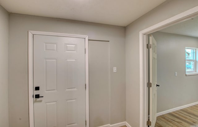hall with wood finished floors and baseboards