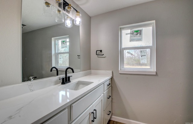 bathroom featuring vanity and baseboards