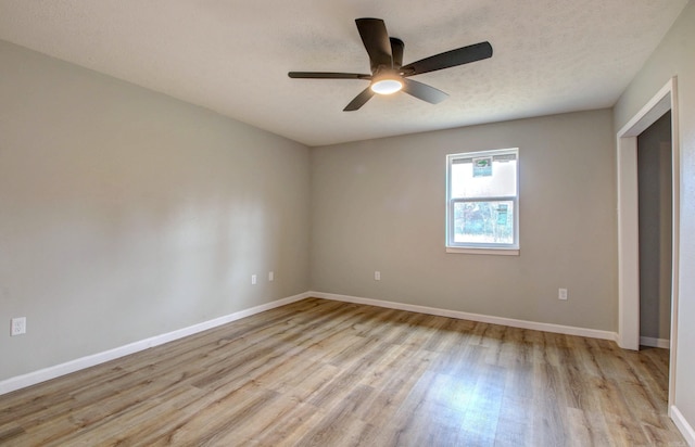 unfurnished bedroom with light wood-type flooring, baseboards, a ceiling fan, and a textured ceiling