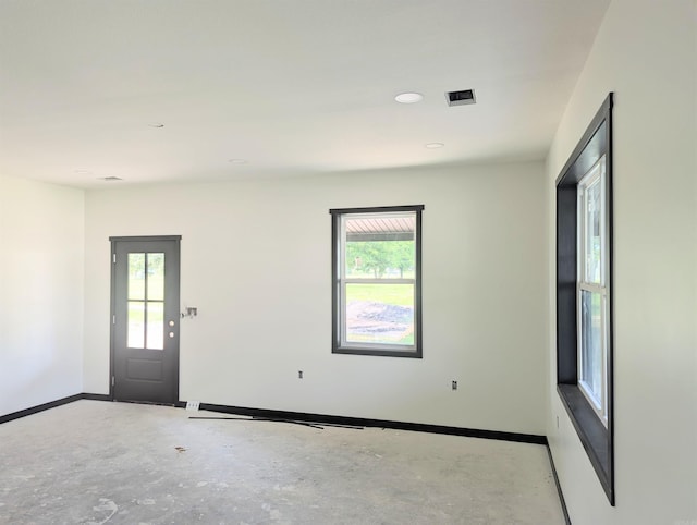 1108 S Dodd St, Rector, AR 72461 - empty room featuring plenty of natural light, baseboards, unfinished concrete floors, and recessed lighting