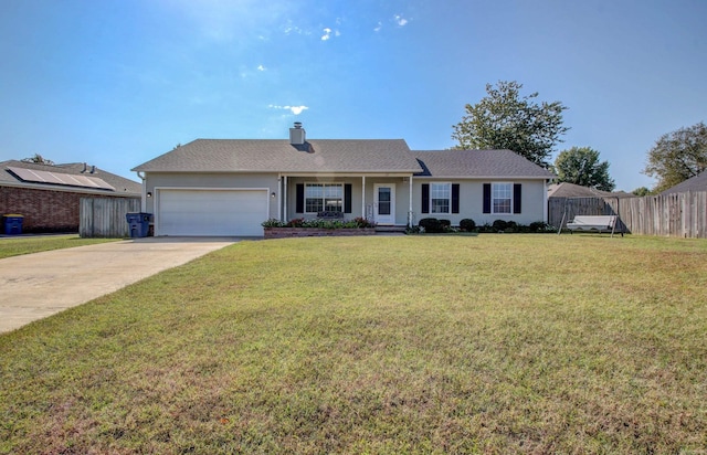 ranch-style home with an attached garage, a chimney, driveway, and covered porch
