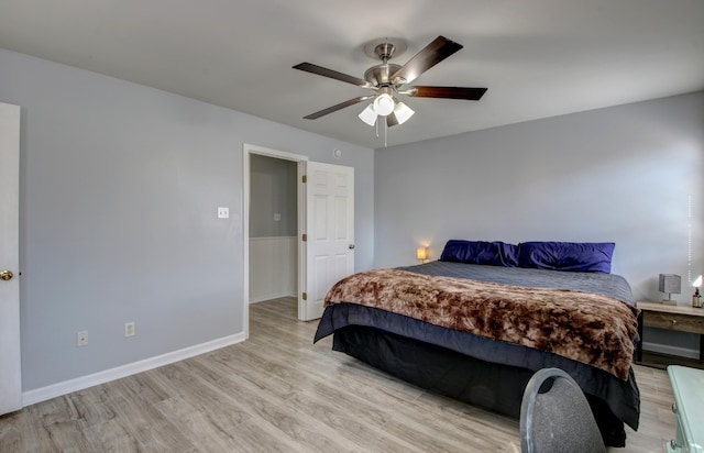 bedroom with light wood finished floors, baseboards, and ceiling fan