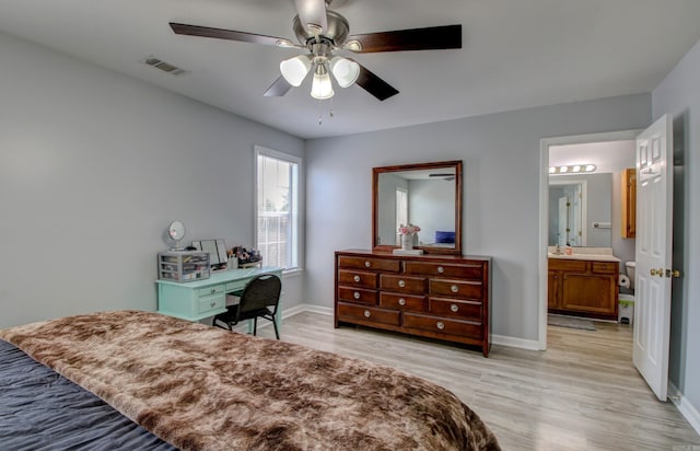 bedroom featuring light wood-style floors, baseboards, ceiling fan, and ensuite bathroom