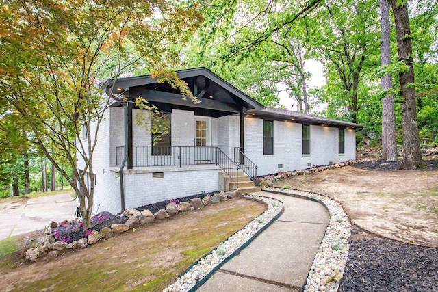 9008 Leatrice Dr, Little Rock, AR 72227 - view of front of home with brick siding, a porch, and crawl space