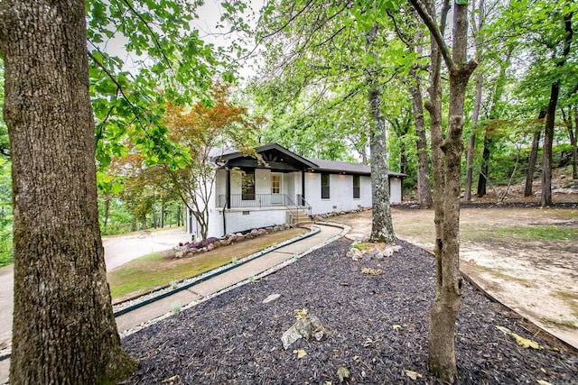 9008 Leatrice Dr, Little Rock, AR 72227 - view of front of house featuring covered porch, brick siding, and crawl space