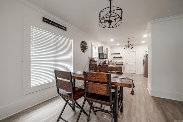 1626 Logan St, Arkadelphia, AR 71923 - dining space featuring a chandelier, light wood-style floors, baseboards, crown molding, and recessed lighting