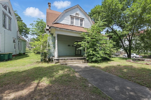 2100 State St, Little Rock, AR 72206 - dutch colonial featuring a porch, a gambrel roof, a front lawn, and a chimney