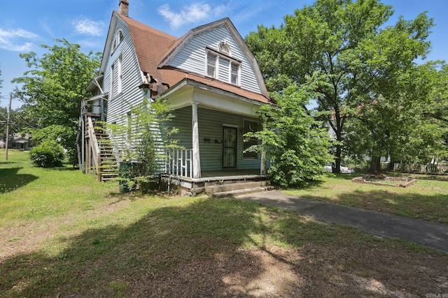 2100 State St, Little Rock, AR 72206 - view of front of property featuring covered porch, a front lawn, a chimney, and a gambrel roof