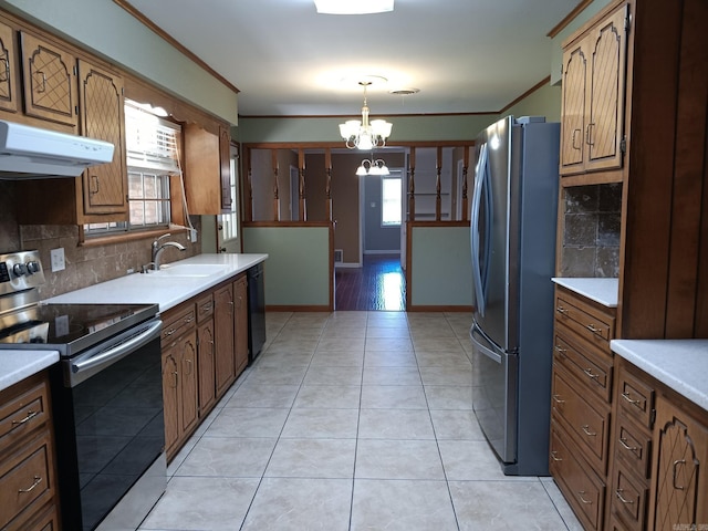 162 Cloverdale, Searcy, AR 72143 - kitchen with appliances with stainless steel finishes, a chandelier, a sink, decorative backsplash, and under cabinet range hood