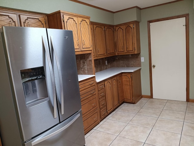 162 Cloverdale, Searcy, AR 72143 - kitchen with stainless steel fridge with ice dispenser, light countertops, tasteful backsplash, ornamental molding, and brown cabinetry