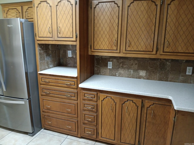 162 Cloverdale, Searcy, AR 72143 - kitchen featuring freestanding refrigerator, light countertops, decorative backsplash, and light tile patterned floors