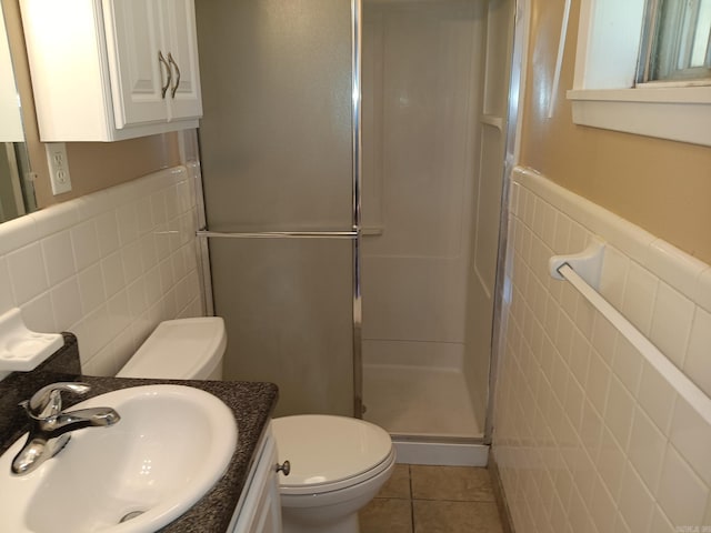 162 Cloverdale, Searcy, AR 72143 - bathroom featuring tile walls, a stall shower, toilet, tile patterned floors, and vanity