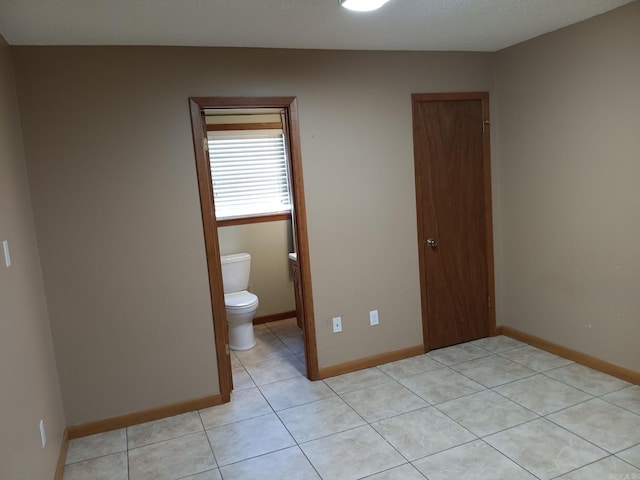 162 Cloverdale, Searcy, AR 72143 - unfurnished bedroom featuring light tile patterned floors, baseboards, and a closet