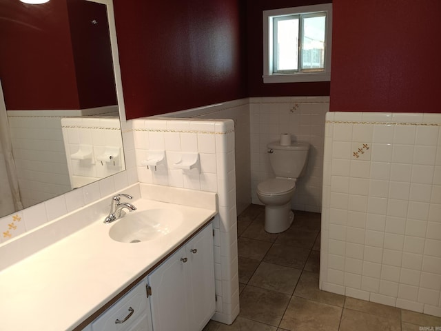 162 Cloverdale, Searcy, AR 72143 - bathroom featuring tile walls, wainscoting, toilet, tile patterned floors, and vanity
