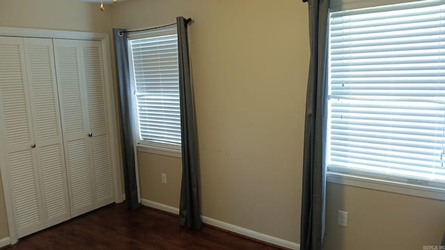 162 Cloverdale, Searcy, AR 72143 - unfurnished bedroom featuring a closet, baseboards, and dark wood-type flooring