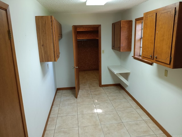 162 Cloverdale, Searcy, AR 72143 - corridor with a textured ceiling, light tile patterned floors, and baseboards