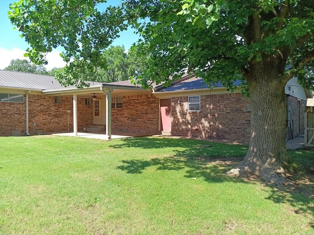 162 Cloverdale, Searcy, AR 72143 - rear view of house featuring a yard, a patio, brick siding, and metal roof
