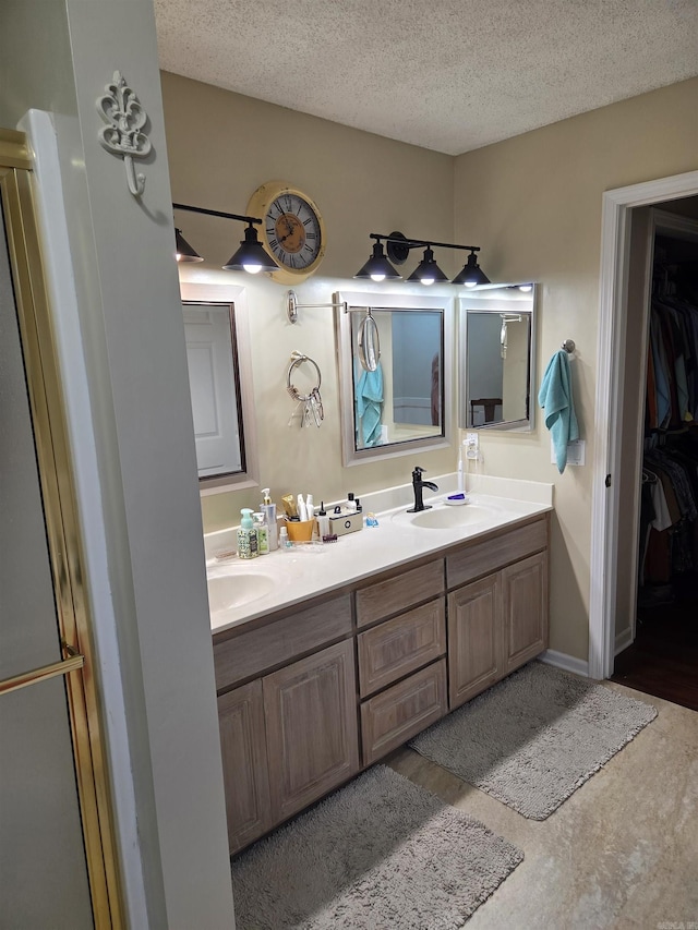 76 Justa Via Way, Hot Springs Village, AR 71909 - bathroom with a textured ceiling, double vanity, and a spacious closet