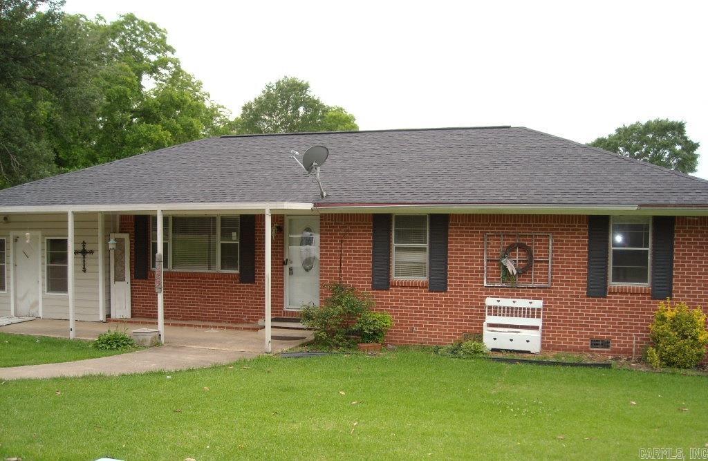 526 N 5th St, Hampton, AR 71744 - view of front of property featuring a front lawn, brick siding, roof with shingles, crawl space, and a porch
