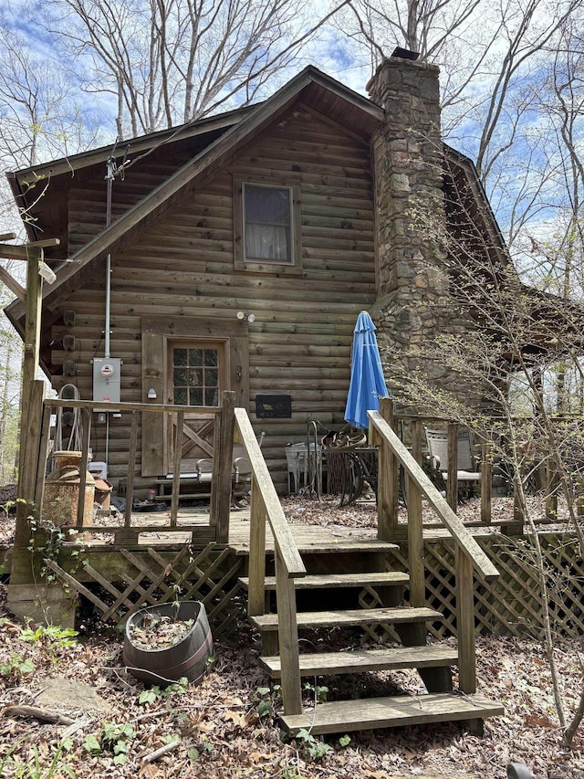 803 Carmichael Rd, Bryant, AR 72022 - back of property featuring a wooden deck, log siding, a chimney, and stairs