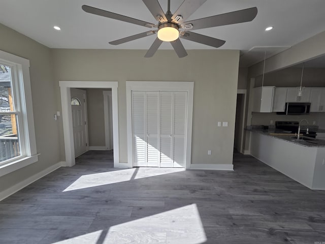 1017 Jefferson, Little Rock, AR 72204 - kitchen featuring white cabinets, dark wood finished floors, baseboards, a sink, and ceiling fan