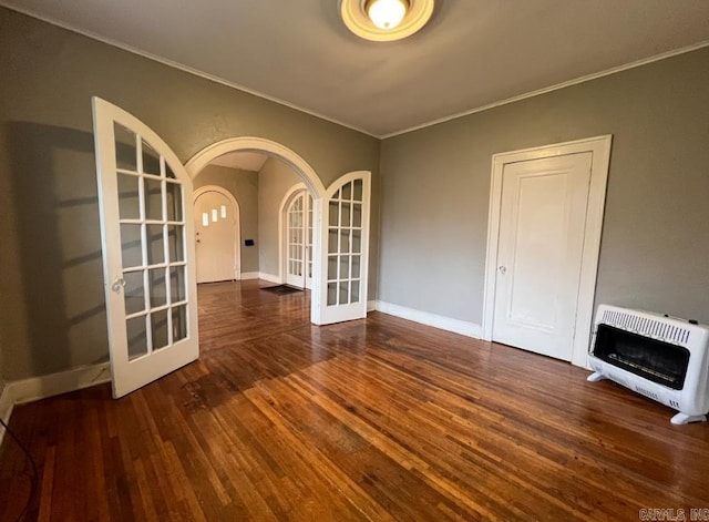 3224 W 11th St, Little Rock, AR 72204 - unfurnished room with french doors, heating unit, arched walkways, ornamental molding, and wood finished floors