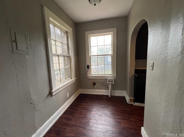 3224 W 11th St, Little Rock, AR 72204 - unfurnished room with arched walkways, wood finished floors, plenty of natural light, baseboards, and a textured wall