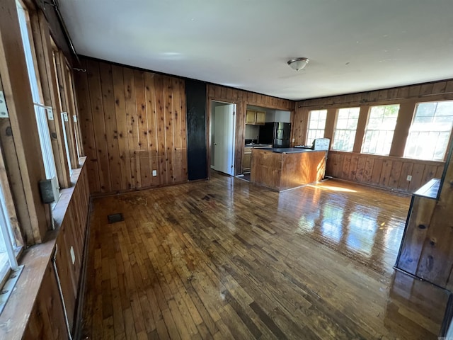 3224 W 11th St, Little Rock, AR 72204 - unfurnished living room featuring dark wood-type flooring and wood walls