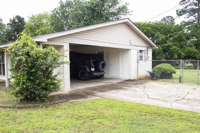100 Elizabeth St, Prescott, AR 71857 - view of side of home with concrete driveway, board and batten siding, and a carport