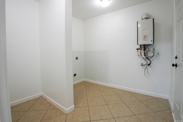 3516 Vickie Dr, Bryant, AR 72022 - clothes washing area featuring electric dryer hookup, light tile patterned floors, tankless water heater, and baseboards