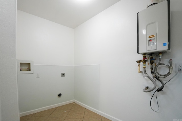 3516 Vickie Dr, Bryant, AR 72022 - laundry area with electric dryer hookup, washer hookup, tankless water heater, light tile patterned floors, and baseboards