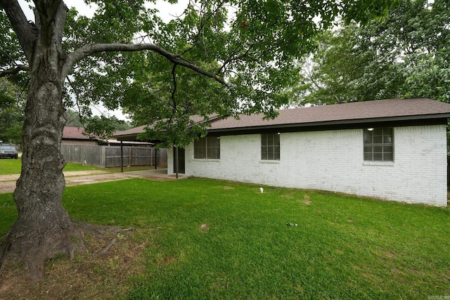 3516 Vickie Dr, Bryant, AR 72022 - rear view of house featuring a carport, brick siding, concrete driveway, and a shingled roof