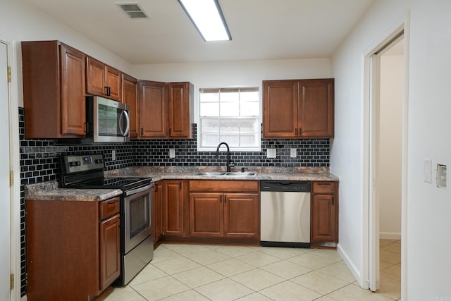 3516 Vickie Dr, Bryant, AR 72022 - kitchen with appliances with stainless steel finishes, a sink, tasteful backsplash, and light tile patterned floors