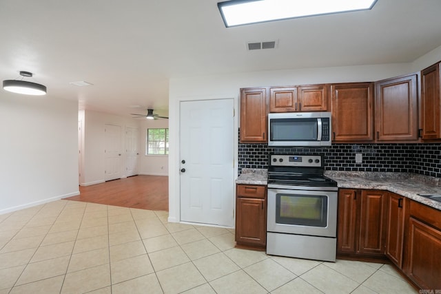 3516 Vickie Dr, Bryant, AR 72022 - kitchen featuring appliances with stainless steel finishes, light tile patterned floors, decorative backsplash, and a ceiling fan