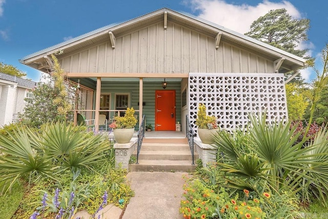 608 E 5th St, El Dorado, AR 71730 - view of front facade featuring a porch and board and batten siding