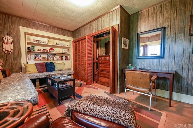608 E 5th St, El Dorado, AR 71730 - sitting room with wood finished floors, wood walls, ornamental molding, and built in shelves