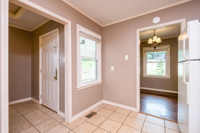 15 Coolwood Dr, Little Rock, AR 72202 - foyer entrance with ornamental molding, a chandelier, light tile patterned floors, and baseboards