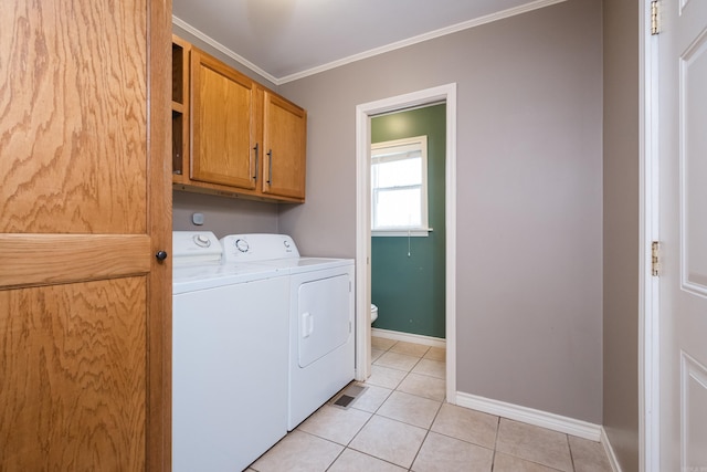 15 Coolwood Dr, Little Rock, AR 72202 - washroom featuring separate washer and dryer, baseboards, cabinet space, light tile patterned floors, and crown molding