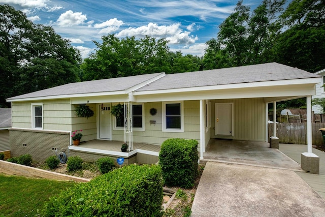 15 Coolwood Dr, Little Rock, AR 72202 - ranch-style house with concrete driveway, a porch, a carport, and fence