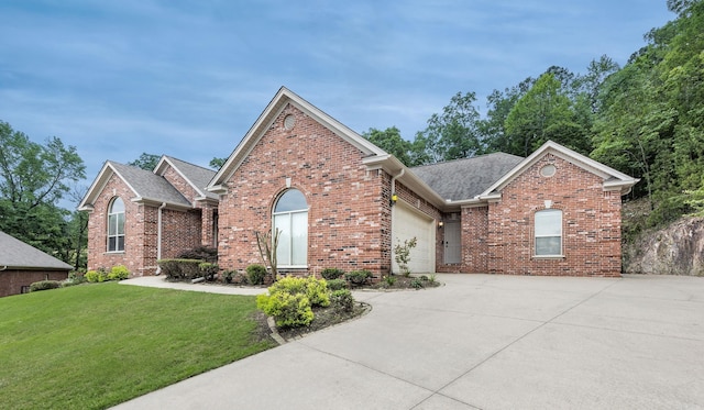 110 Clervaux Cir, Little Rock, AR 72223 - traditional-style house with concrete driveway, brick siding, an attached garage, a front lawn, and roof with shingles