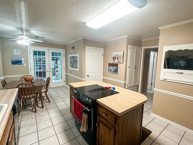 53 White Oak Cir, Searcy, AR 72143 - kitchen featuring black appliances, french doors, a textured ceiling, light tile patterned floors, and butcher block countertops