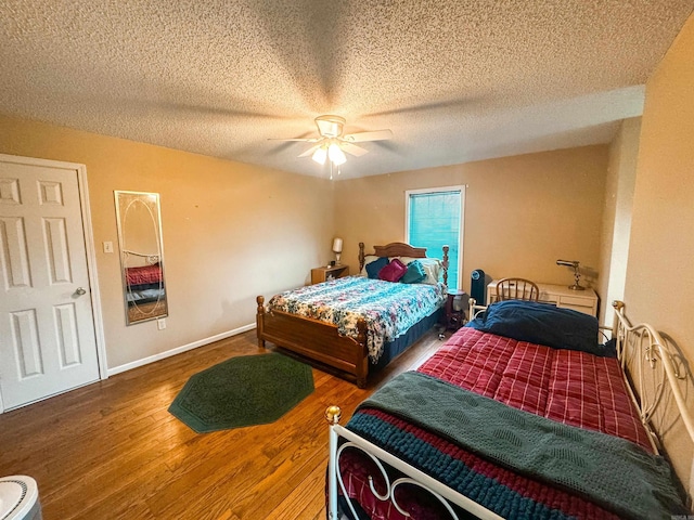 53 White Oak Cir, Searcy, AR 72143 - bedroom with wood finished floors, a textured ceiling, a ceiling fan, and baseboards