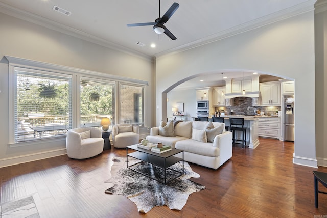 43 Tournay Cir, Little Rock, AR 72223 - living area with arched walkways, crown molding, ceiling fan, dark wood-style floors, and a towering ceiling